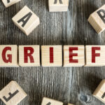 wooden blocks that spell the word grief