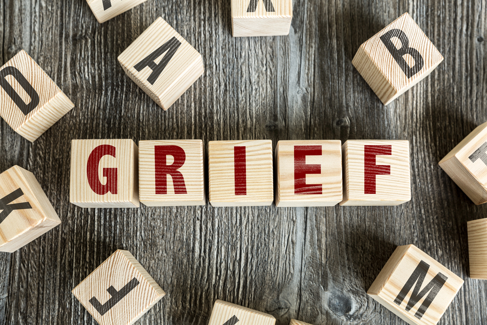 wooden blocks that spell the word grief